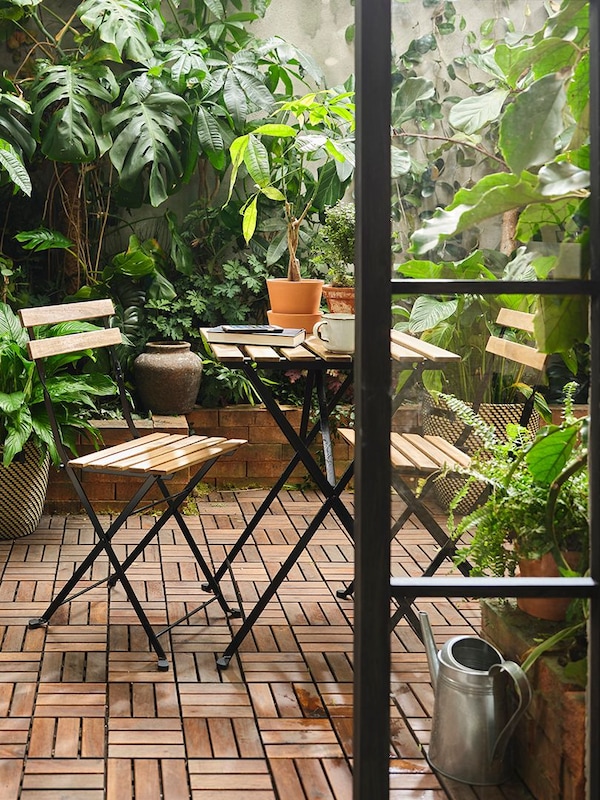 A black/light brown stained TÄRNÖ table+2 chairs, outdoor outside